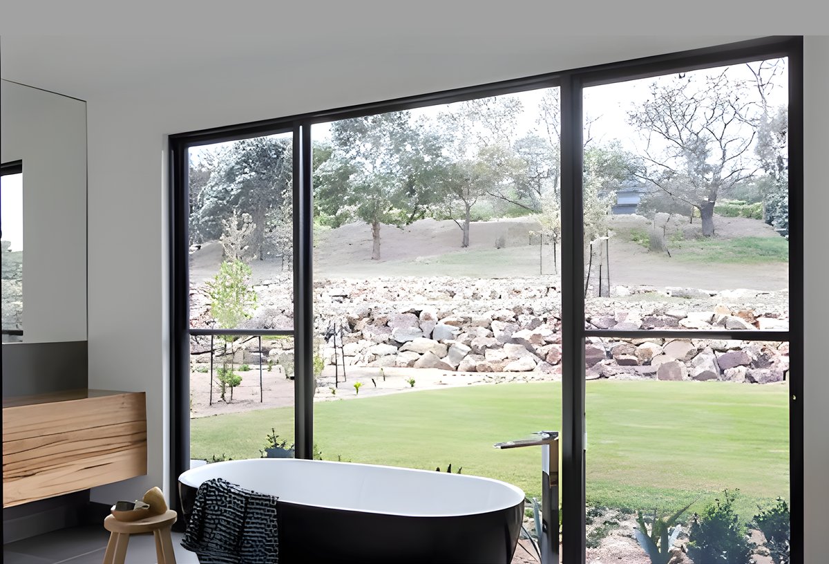Double hung aluminum window overlooking a garden
